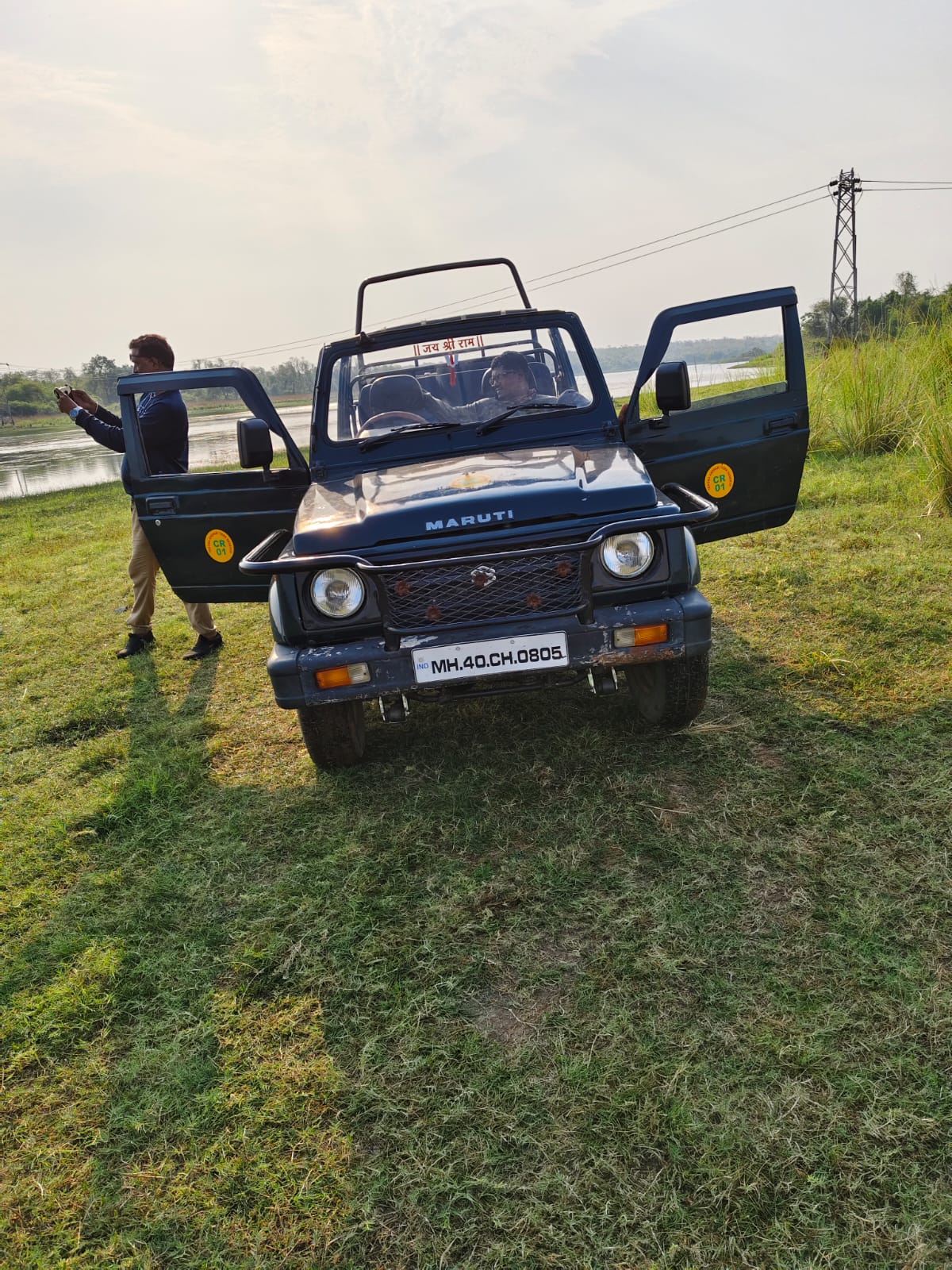 Safari jeep beside grassland in Tadoba